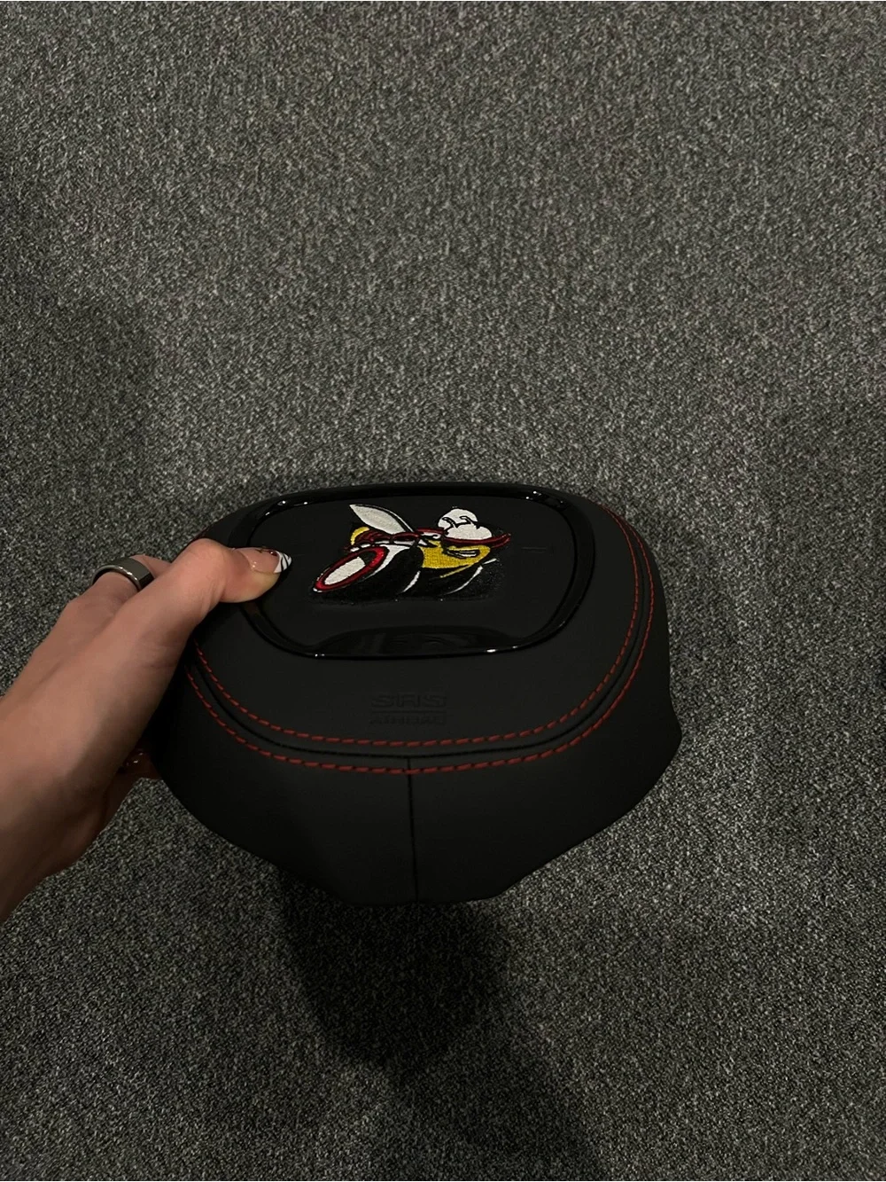 Black Airbag Cover with Red Stitching and Bee Patch